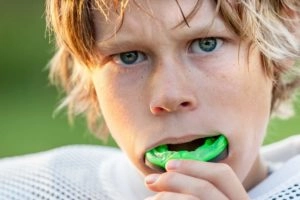 Boy with sports mouthguard michigan