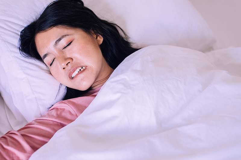 sleeping woman grinding teeth