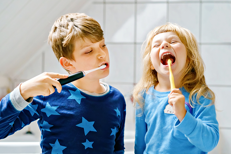 Two kids brushing their teeth