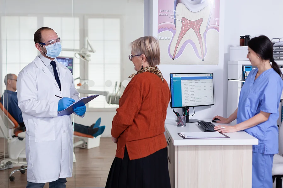 older patient at dental office with dentist